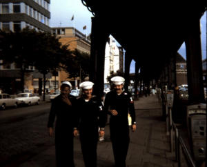 E. Fischer (?), T. Quinn (?) and Ron Walton coming from round bar Hamburg, Germany 1970